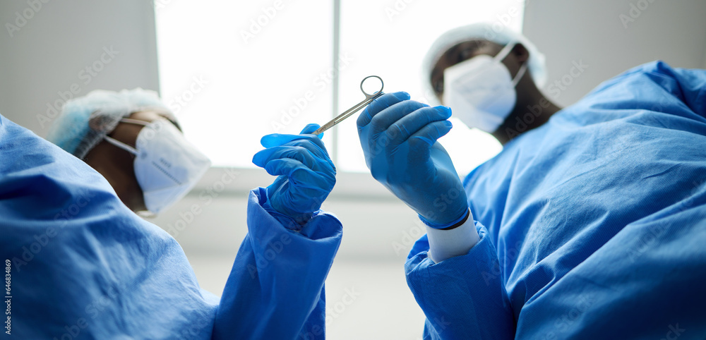 Surgery team, scissors and a doctor in a hospital or theatre to start operation with surgical tools.