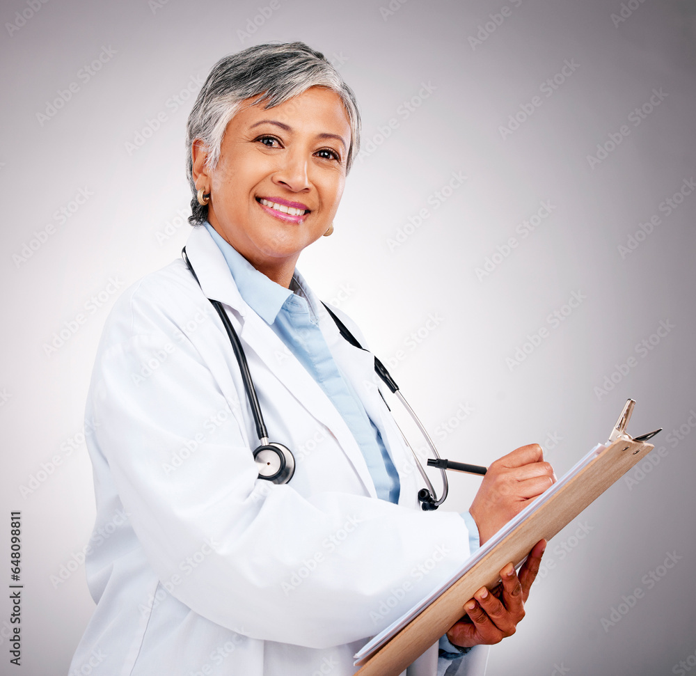 Planning, notes and portrait of woman or doctor writing feedback, healthcare advice or results. Smile, hospital and mature medical employee or nurse with insurance documents on a studio background
