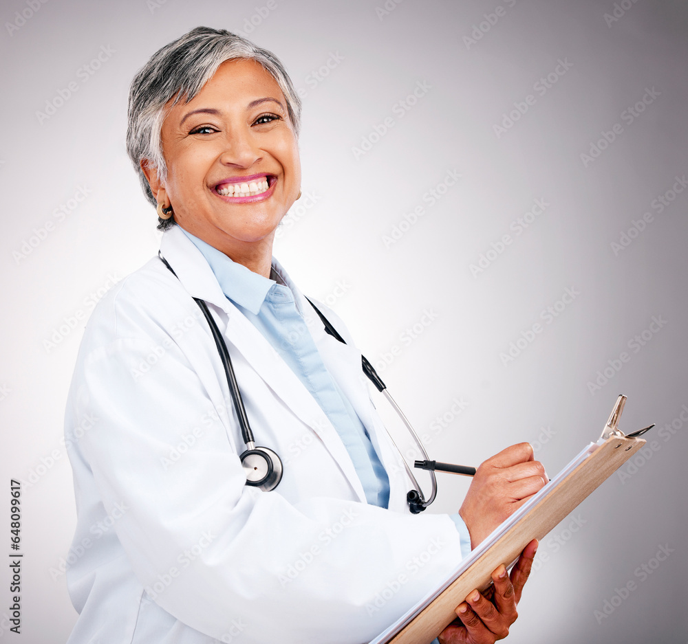 Happy, notes and portrait of woman or doctor writing feedback, healthcare advice or results. Smile, hospital and mature medical employee or nurse with insurance documents on a studio background