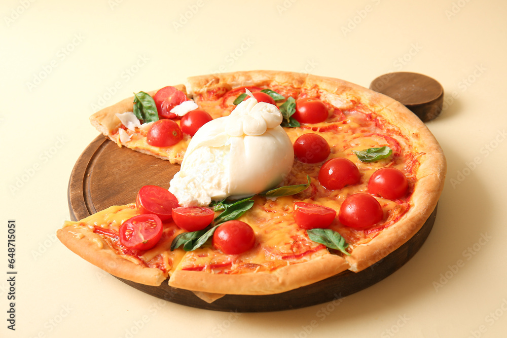 Wooden board of tasty pizza with Burrata cheese on yellow background