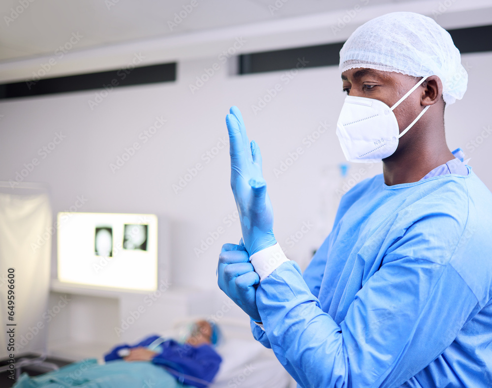 Doctor, man and surgery, put glove on hand and start operation with face mask, PPE and healthcare at hospital. Surgeon ready for treatment, health and medical professional with patient for wellness
