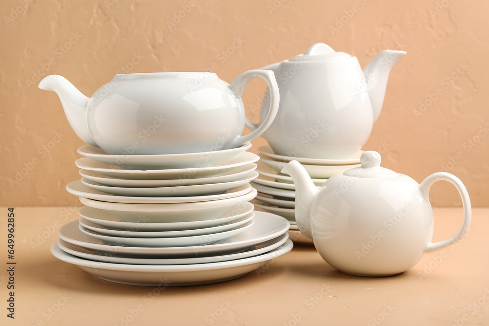 Set of clean dishware on color background