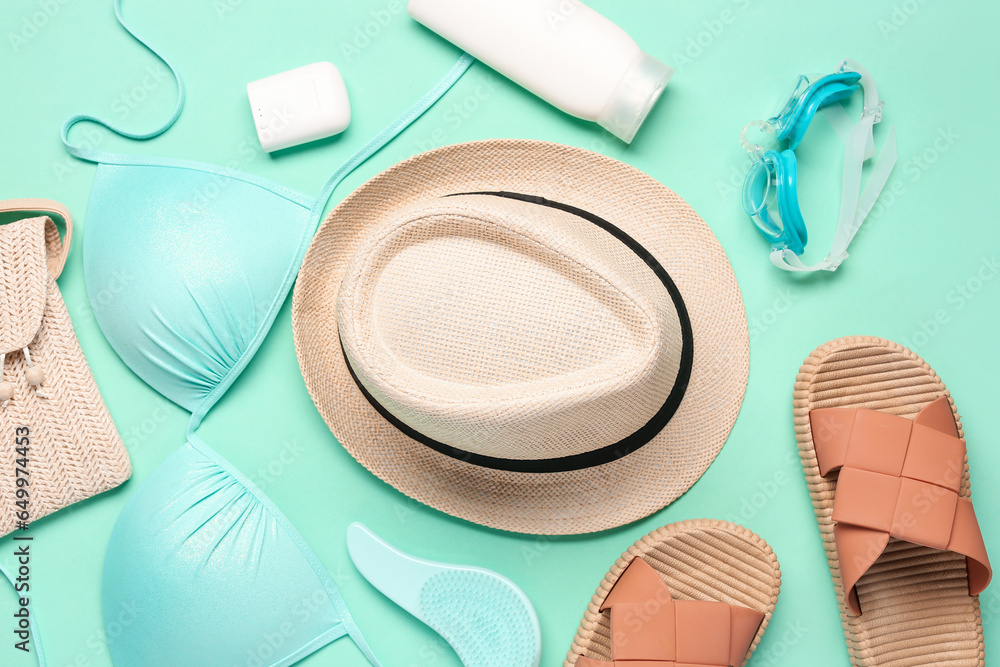 Composition with female beach accessories and bottle of sunscreen cream on color background