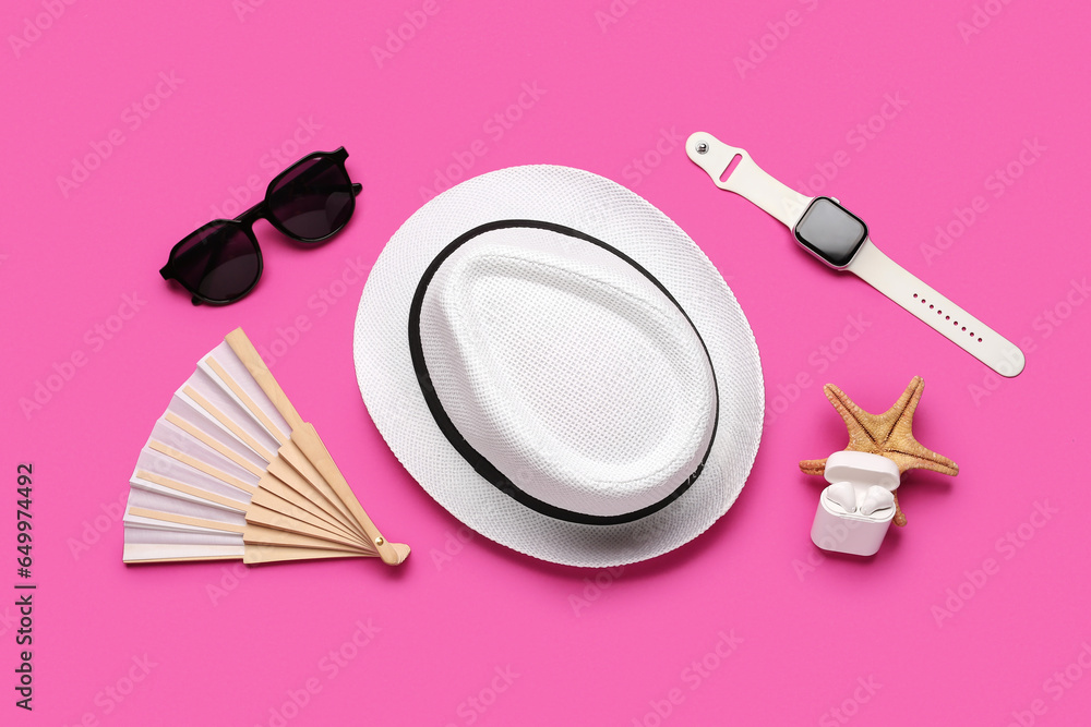 Composition with beach accessories, smart watch and earphones on color background