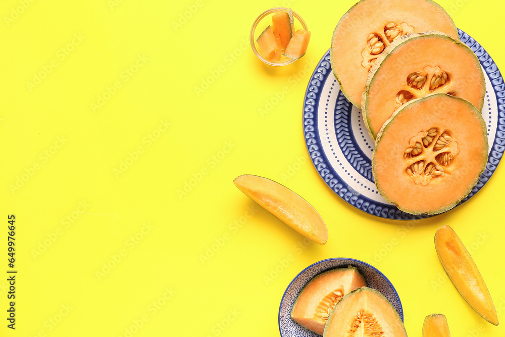 Plate and bowl with pieces of sweet melon on yellow background