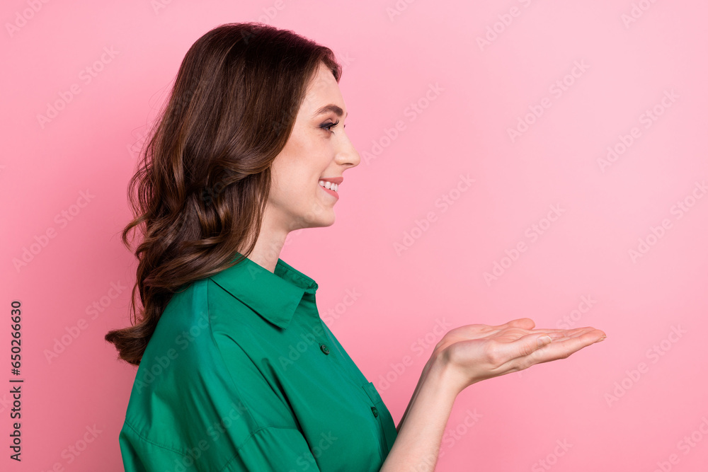 Photo of cute pretty lady wear green shirt holding arms empty space isolated pink color background