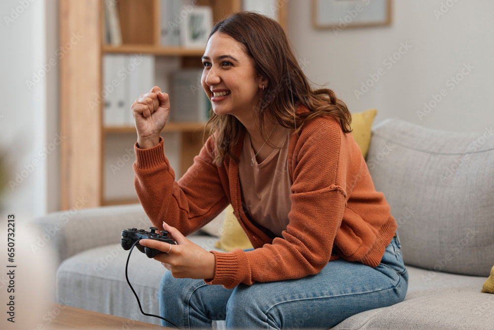 Success, happy and a woman gaming on the sofa with a win, celebration and excited about competition. Smile, house and a girl with a console for a game, entertainment and achievement with technology