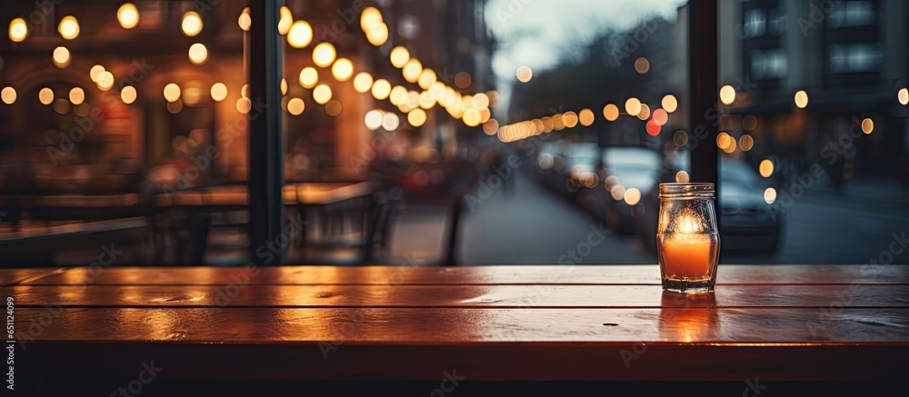Product background with empty table on blurred dark cafe restaurant windows