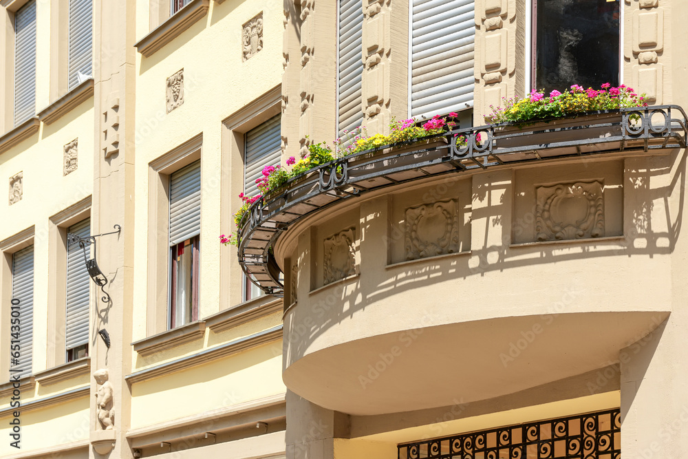 Balcony of beautiful building with flowers in city