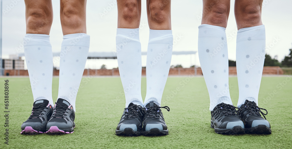 Legs, shoes and woman hockey team outdoor on a field for a game or competition together in summer. Fitness, training or sports with people on a pitch of a grass for exercise or teamwork on match day