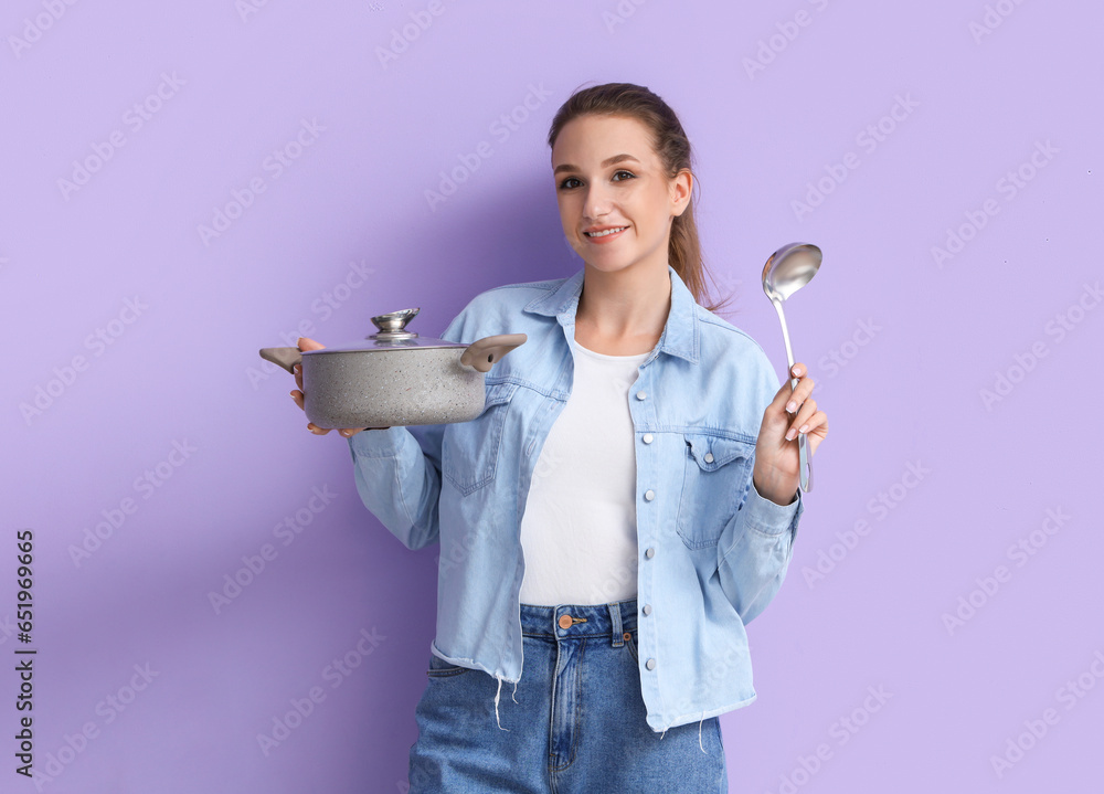 Young woman with ladle and pot of chicken soup on lilac background