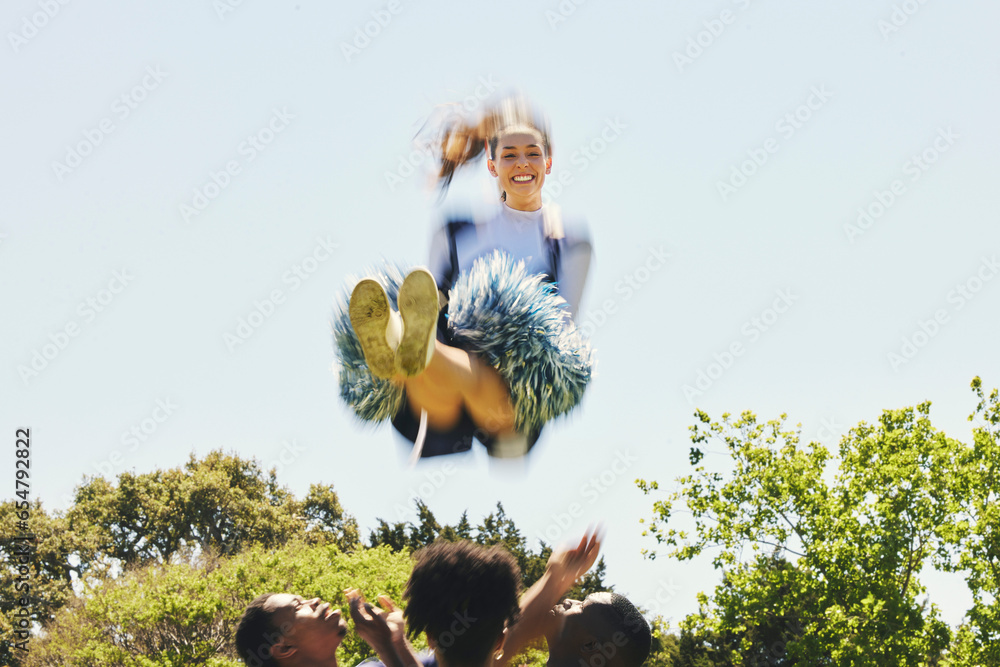 Fitness, energy and woman cheerleader on a field for motivation or support practice with team. Sports, cheerleading and female athlete training in air and dance with blur motion at competition.