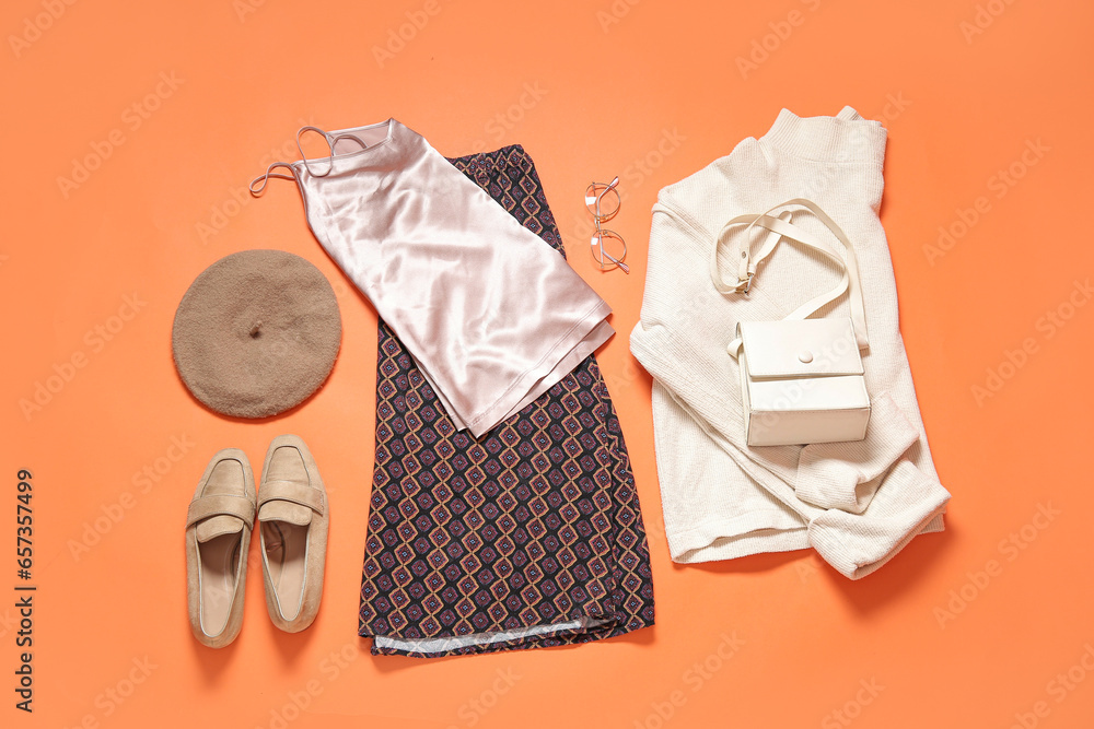 Set of stylish female clothes with shoes and accessories on color background