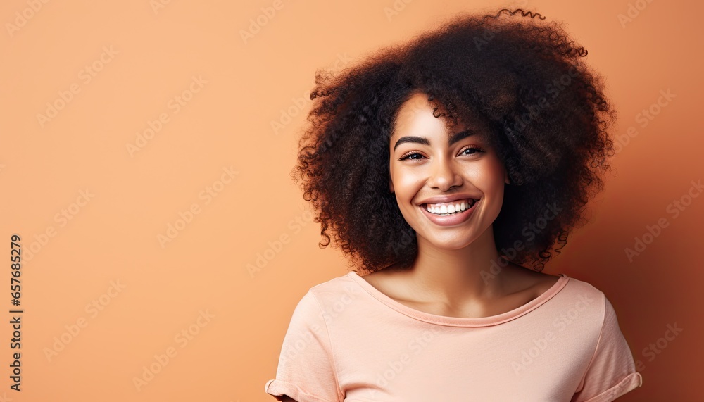 Portrait of a beautiful smiling African young woman with curly hair.