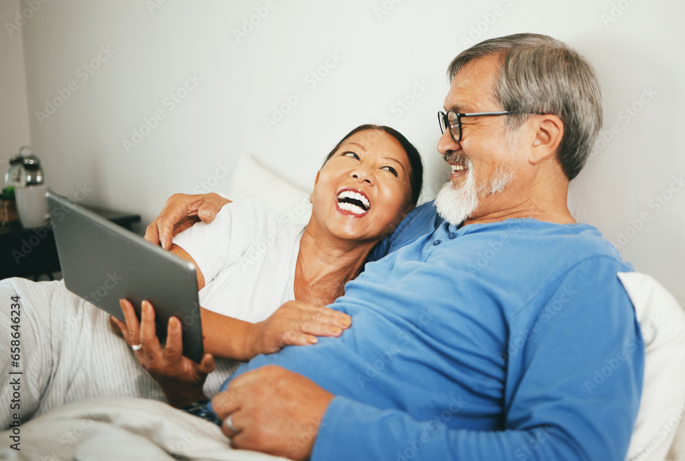 Tablet, mature or happy couple in bed for movie watching on website subscription via internet connection. Meme, home or mature woman laughing at comedy with an Asian man streaming film on tech online