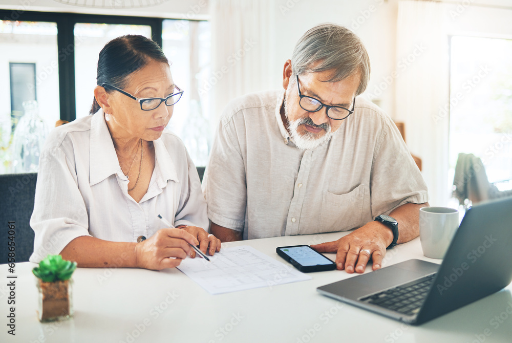 Senior couple, phone and finance in budget planning, invoice or documents together on table at home. Mature man and woman writing in financial plan, expenses or bills with paperwork on desk at house