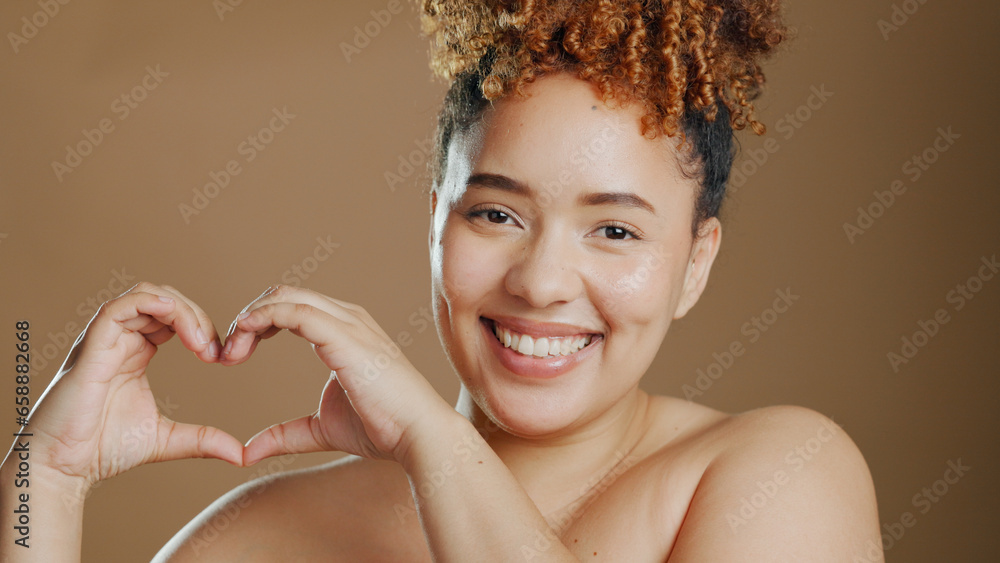 Portrait, happy woman and heart sign in studio with mockup for beauty and love on brown background. African person and smile for confidence, change or results in dermatology, skincare or wellness