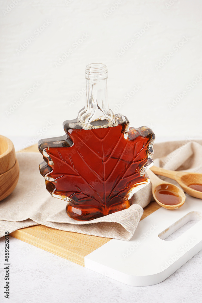 Bottle tasty maple syrup on white table