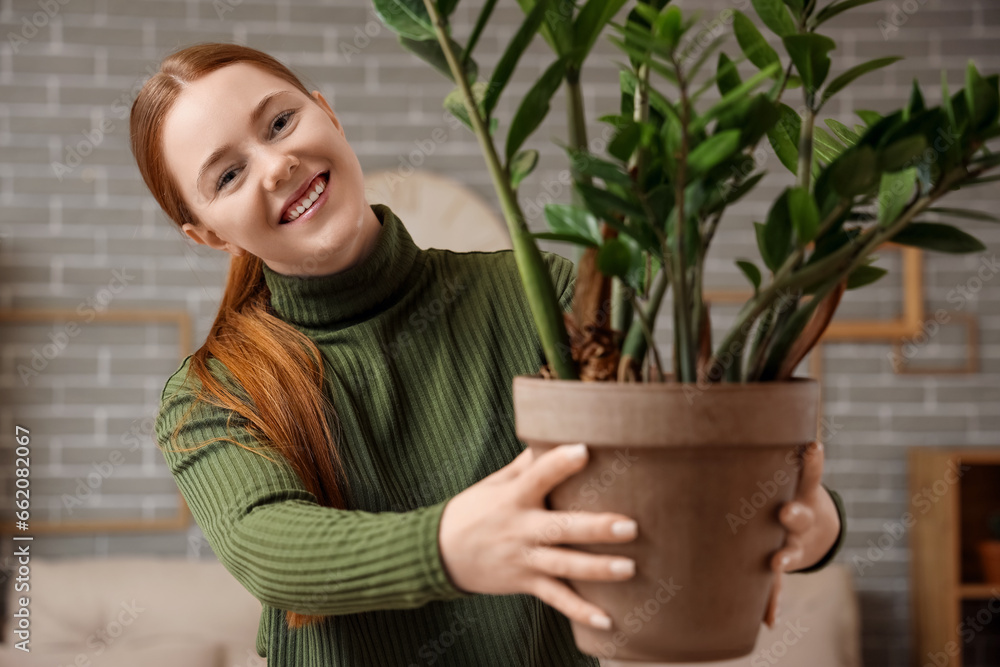 Young woman with plant at home