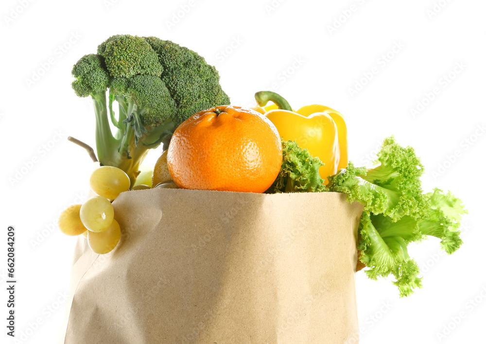 Paper bag with fruits and vegetables on white background. Grocery shopping