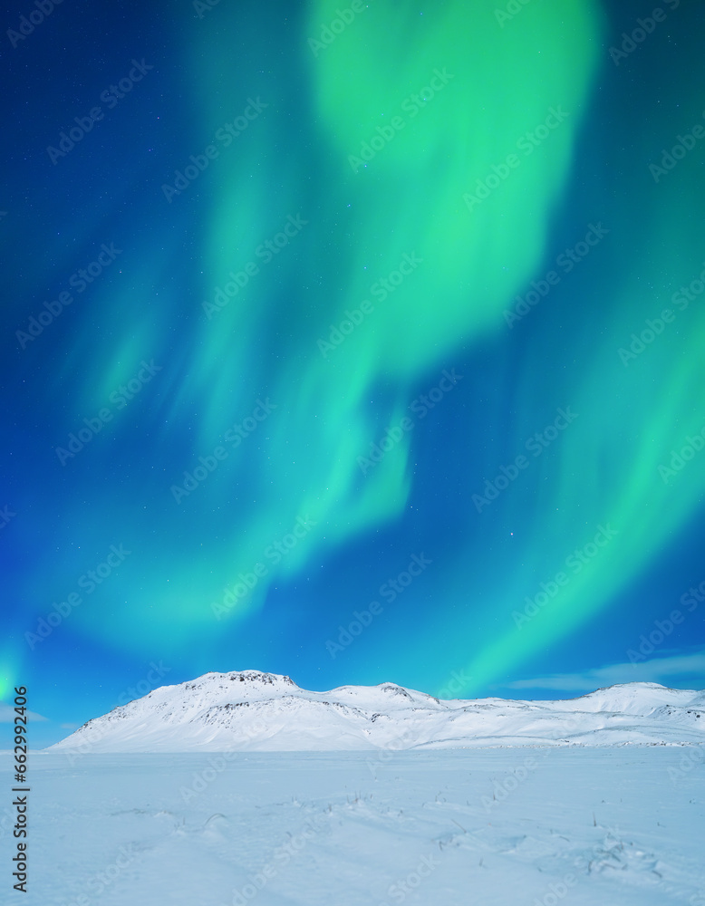 Aurora Borealis. Northern lights and clear skies. Nature. Scandinavian countries. Snow and ice on the mountains. Landscape in winter time. Photo for background and wallpaper.
