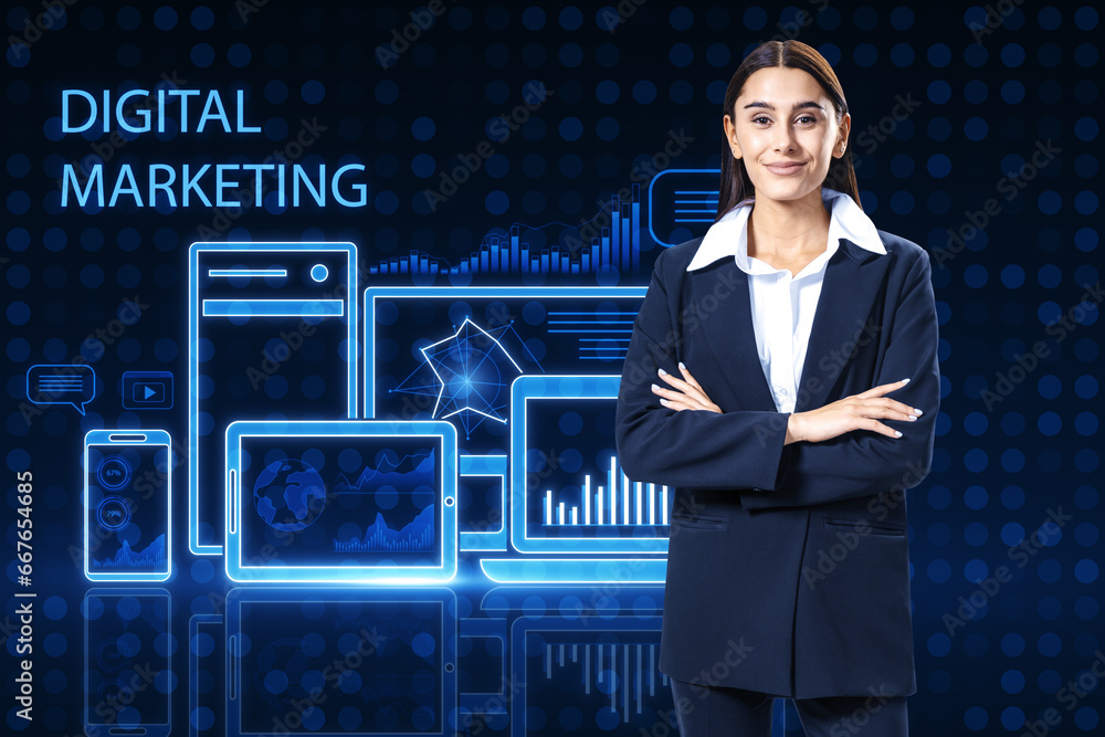 Attractive happy european woman with folded arms standing on blue pixel background with gadgets and business chart hologram. Digital marketing, finance, social network and online service concept.