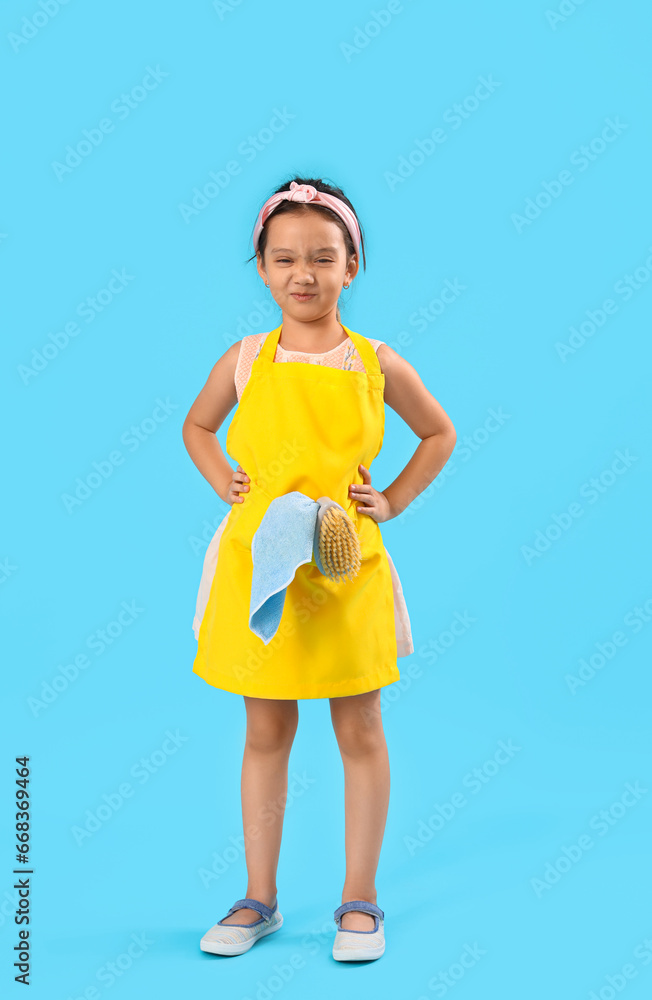 Displeased little janitor on blue background