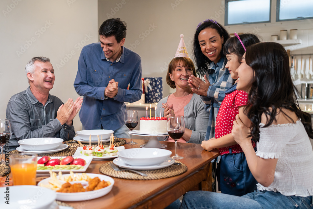Multi-ethnic big family having birthday party for senior grandmother. 