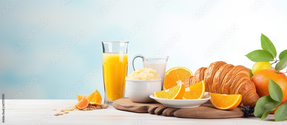 Assorted set of nutritious morning meal Includes orange juice granola croissant coffee and fresh fruit