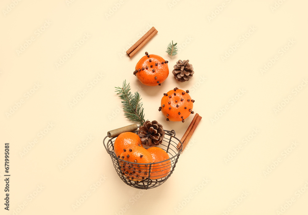 Basket with pomander balls and cinnamon on yellow background