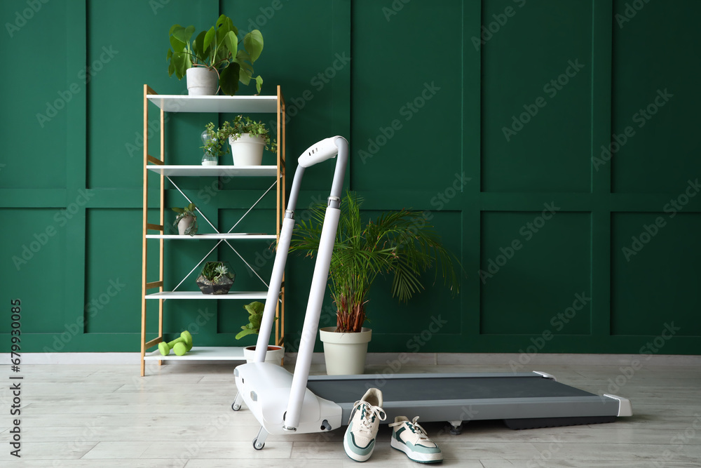 Interior of room with treadmill and plants