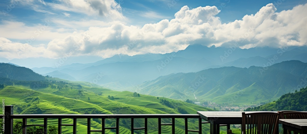 picturesque summer landscape, the azure sky adorned with fluffy white clouds hung over the lush green mountains, accentuating the beauty of the nature, architecture, and agriculture as the farmer