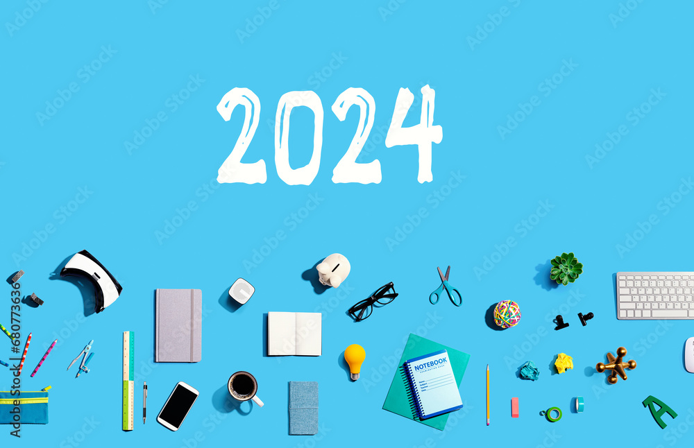 2024 new year concept with collection of electronic gadgets and office supplies