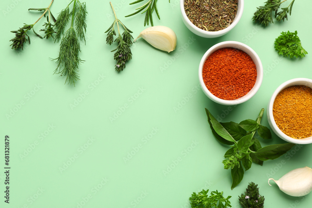 Composition with aromatic spices and fresh herbs on color background