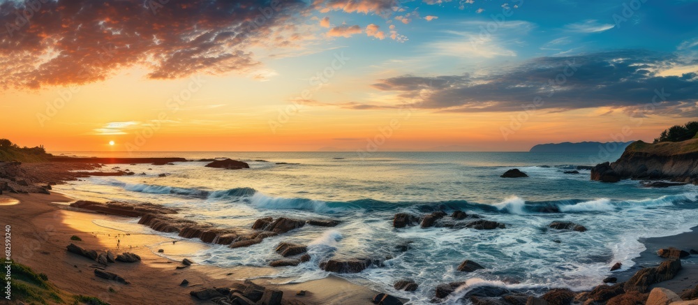 As the sun rose over the cobalt blue sea, the waves danced along the shores of Chiba, Japan, creating a mesmerizing sight. With a picturesque view of the glittering waves and the beautiful blue sky
